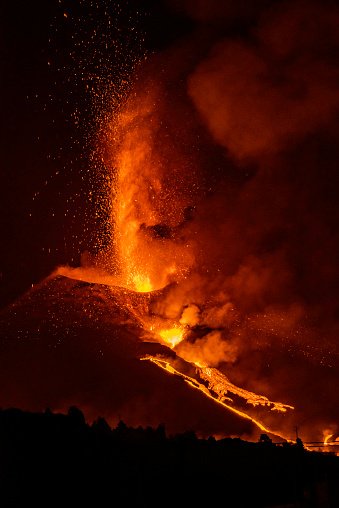 The volcano of cumbre vieja, in La Palma, exploding and illuminating the sky