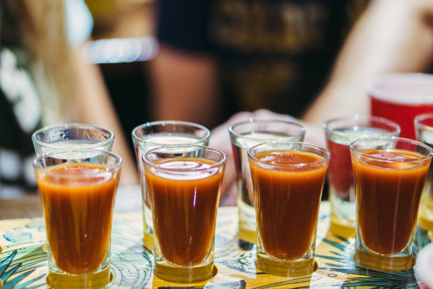 istock Alcohol. Glasses with alcohol. People drink alcohol. 1346057027