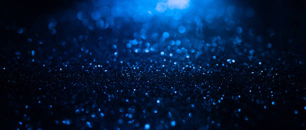 istock Abstract background of blue glitter lights. De-focused background. Banner size 1346059791