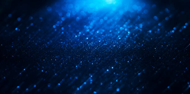 istock Abstract background of blue glitter lights. De-focused background. 1346059796