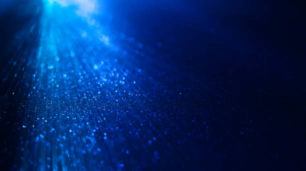 istock Abstract background of blue glitter lights. De-focused background. Banner size 1346060821