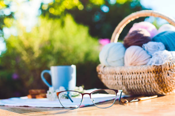 女性の趣味。良い晴天の外のかぎ針編みや編み物のアクセサリー - knitting residential structure glasses hot drink ストックフォトと画像