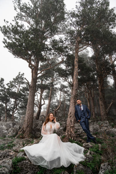 istock fun bride and groom in a mysterious misty mountain forest. honeymoon 1346064329