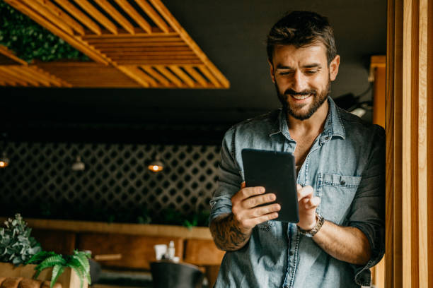 istock Cheerful freelancer holding a digital tablet indoors 1346064579