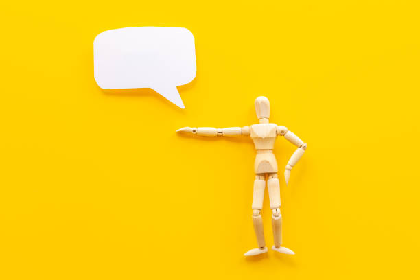 istock Wooden man figure with speech bubble banner 1346064648
