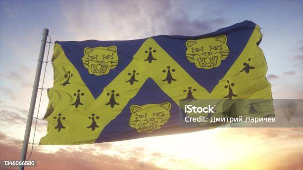 Shropshire Flag England Waving In The Wind Sky And Sun Background 3d Rendering Stock Photo - Download Image Now