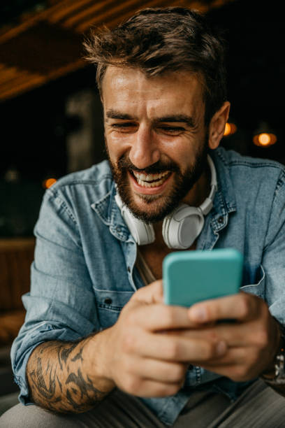 istock Wathing funny videos on the phone while waiting 1346066900