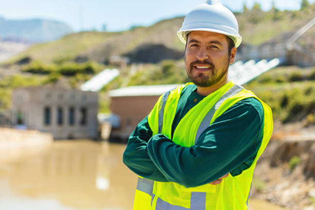 Large Volume Water Transfer Pipes and Pump System Maintenance and Inspection of Waterworks and Irrigation Utilities Equipment Materials and Mixed Ethnic Group Workers Western USA Photo Series stock photo