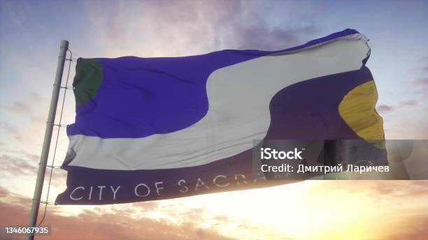 Sacramento City Flag Waving In The Wind Sky And Sun Background 3d Rendering Stock Photo - Download Image Now