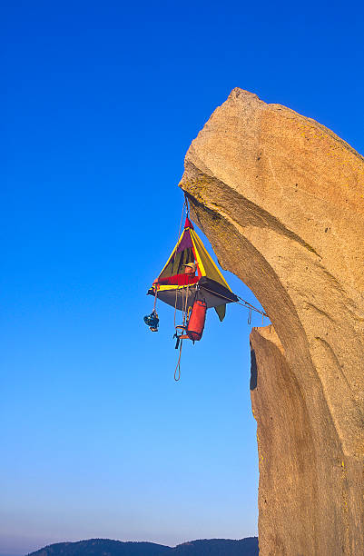 Camping tent hanging of the edge of a cliff stock photo
