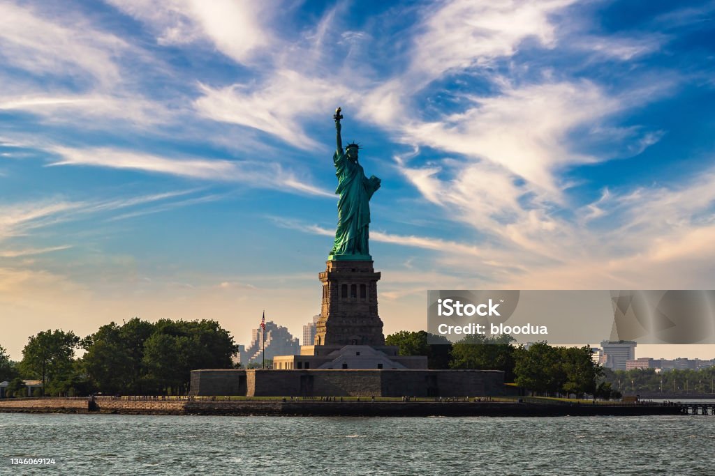 Statue of Liberty at sunset Statue of Liberty at sunset in New York City, NY, USA Architecture Stock Photo