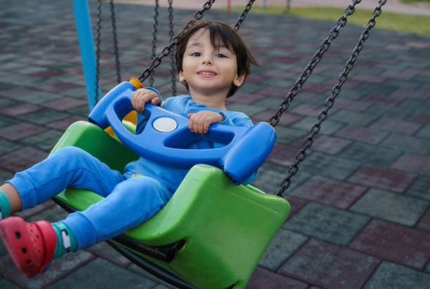 istock Cute little boy playing at the park 1346070933