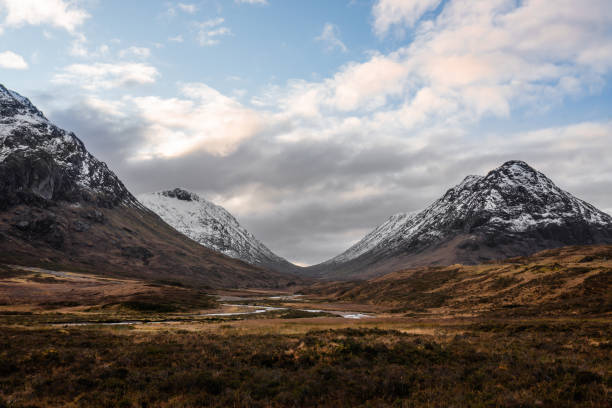 Glencoe Valley with Snow Capped Mountains in Scotland stock photo