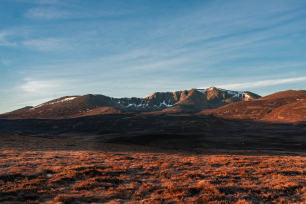Cairngorm Snow Mountain Range at Dawn with wilderness foreground stock photo