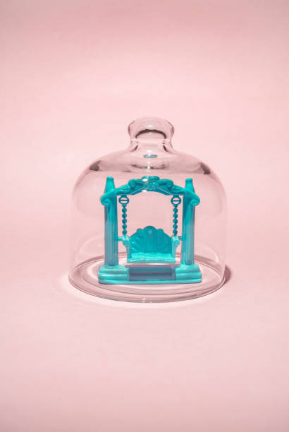 istock Toy garden swing under glass bell jar 1346071879