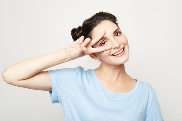 istock beautiful joyful female smiling, demonstrating white teeth 1346073571