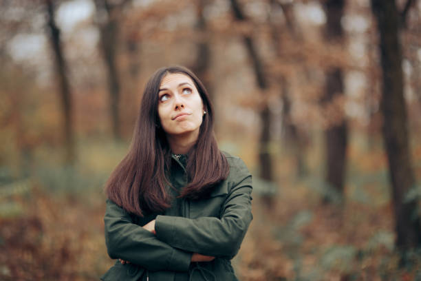 Bored Woman Looking at Foliage in Autumn Season Young person suffering from seasonal affective disorder during fall feeling alone and upset seasonal affective disorder stock pictures, royalty-free photos & images