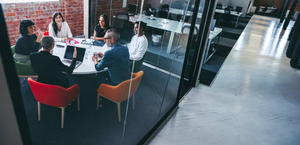 istock Female supervisor briefing her team in an office 1346079822