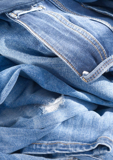 istock background of blue crumpled ripped jeans. Close up 1346080904