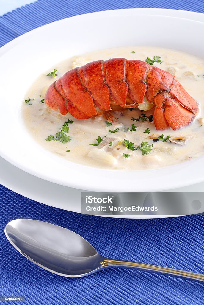 Seafood chowder Rich, smooth appetizer or meal simmered with mussels, clams, fish, onions and celery garnished with savory lobster tail Chowder Stock Photo