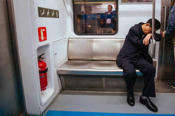 Seoul, South Korea - October 25, 2014: An older man is tired and sleeps in a train carriage in the Seoul subway, Korea
