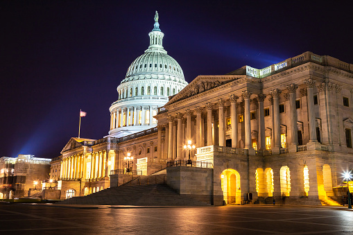 The Capitol Building in Washington, D.C., USA lit up in the early evening.