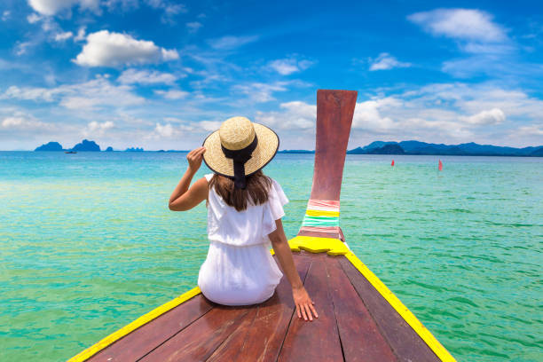 istock Woman on boat in Thailand 1346092241