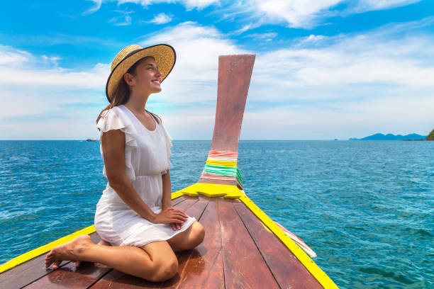 istock Woman on boat in Thailand 1346092249
