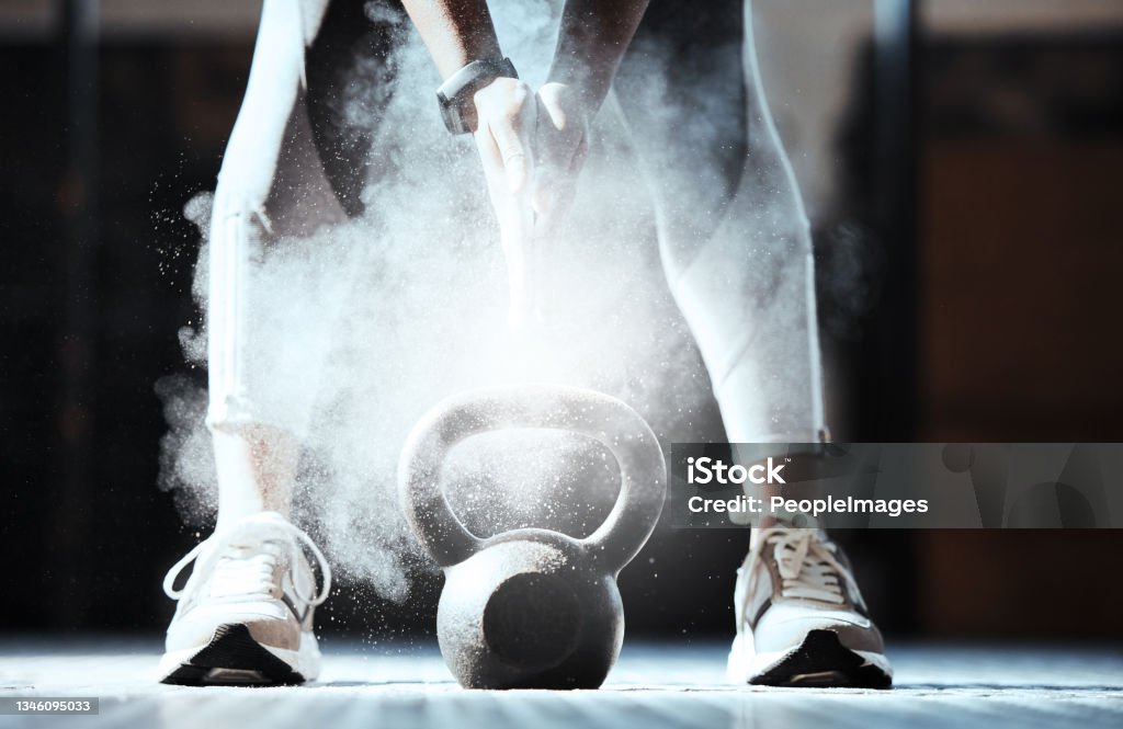 Cropped shot of an unrecognizable woman lifting a kettlebell at the gym Beauty found every where Kettlebell Stock Photo