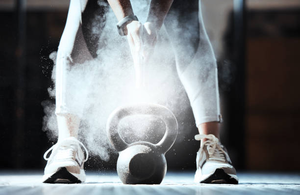 Cropped shot of an unrecognizable woman lifting a kettlebell at the gym Beauty found every where sports chalk stock pictures, royalty-free photos & images