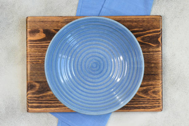 istock empty clean ceramic plate top view and napkin with copy space for text and dissign, dish template for food. 1346097534