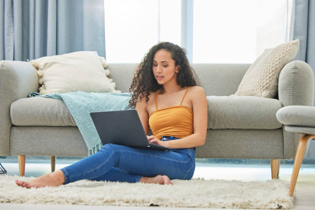 istock Shot of a young woman using her laptop to do some work 1346101685