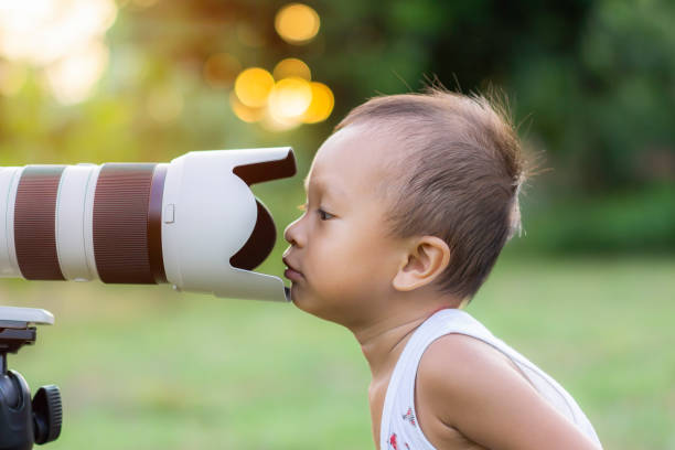 istock Asian children and camera lens 1346101892