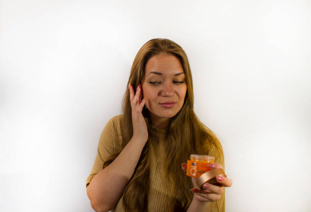 istock young beautiful woman uses face cream 1346101957