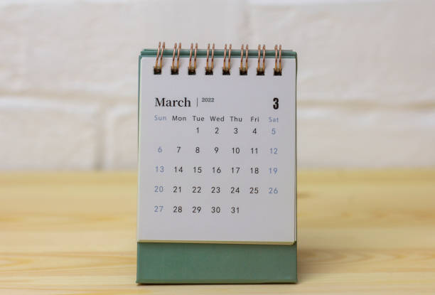 istock Desktop calendar for March 2022 on a table or shelf with a copy of the space. 1346102770