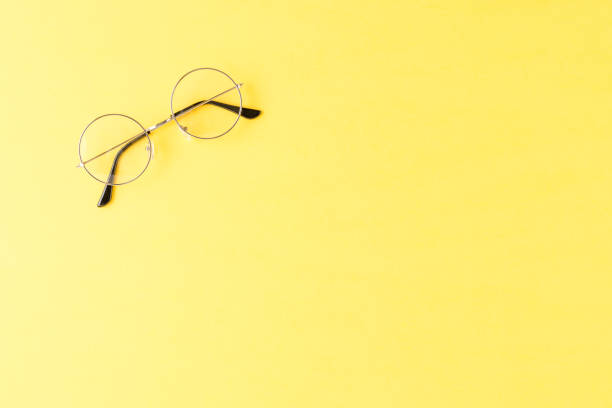istock Fashion eyeglasses on yellow background. Top view 1346108519
