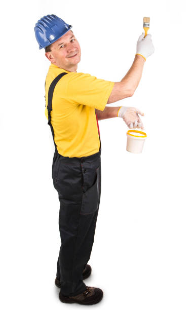 istock A worker with a bucket and a brush is painting something. 1346109555