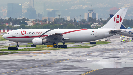 Mexico City, Mexico - August 29, 2021: AeroUnion Airbus A300F XA-LFR  taxing to take-off at Mexico City International Airport during a heavy rain, AeroUnion is one of the mexican freighter airlines with high market volume, Their standard operations from Mexico City Intl. Airport makes the airline one of the most important freighter aerial transportation in Mexico & South America.