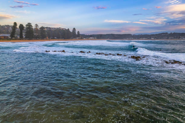 Aerial Sunrise Seascape with Clouds Sunrise seascape with waves and clouds at Avoca Beach on the Central Coast, NSW, Australia. avoca beach photos stock pictures, royalty-free photos & images