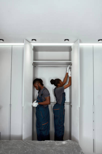 istock Teamwork and professional cooperation concept. Man and woman installing bedroom closet 1346112290