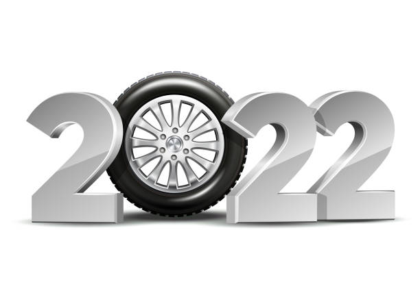 istock New Year numbers 2022 with car tire isolated on white background. 1346113340