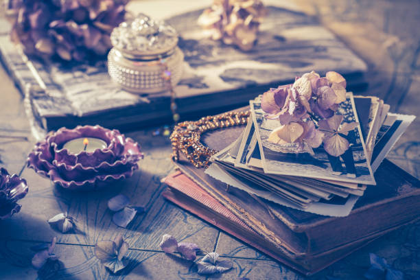 Memories - old family photo album with necklace, old books and dried flowers Memories - old family photo album with necklace, old books and dried flowers and candles still life photos stock pictures, royalty-free photos & images