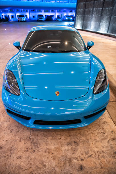 blue Porsche 718 Cayman. top front view. Palm Beach, Florida USA - March 22, 2021: blue Porsche 718 Cayman luxury sport car in palm beach, united states of america. top front view. Porsche is luxury car brand caiman stock pictures, royalty-free photos & images