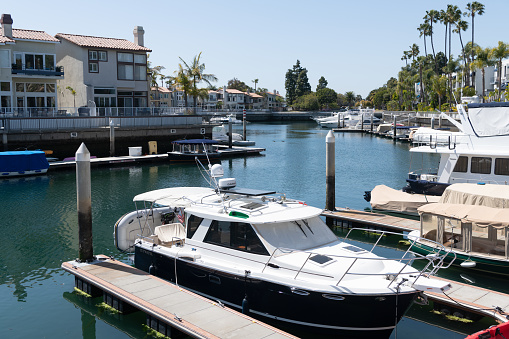 Long Beach, California USA - March 26, 2021: boats and luxury yachts parked at docks in private yachting club. marina in long beach, california. popular tourist destination. boat and sailboat harbor.