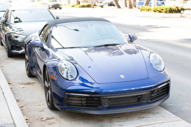 Long Beach, California USA - April 11, 2021: dark blue Porsche 911 Carrera cabriolet retro luxury car in long beach in state of California located within Los Angeles metropolitan area. front view.