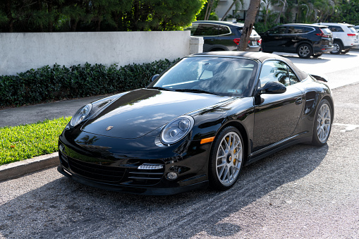 Palm Beach, Florida USA - March 21, 2021: black Porsche 911 cabriolet luxury car parked in palm beach, united states of america. left corner view. Porsche is luxury car brand