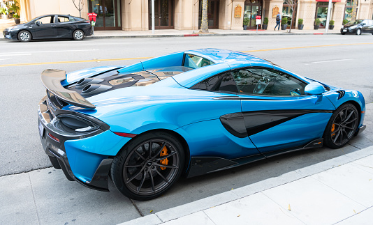 Los Angeles, California USA - April 14, 2021: blue McLaren Automotive Limited 720S luxury supercar parked in LA the U.S. state of California. back side view.