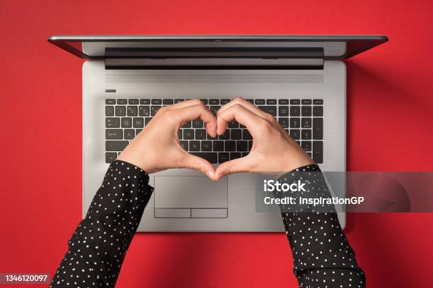 Overhead Photo Of Grey Laptop And Hands With Gesture As Heart Isolated On The Red Backdrop Stock Photo - Download Image Now