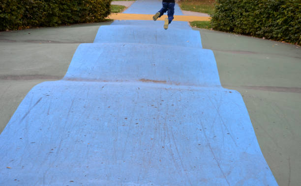 istock Skateboard, skating park for roller skating with a concrete cement surface painted blue and yellow. turns and training waves with obstacles. Freestyle cycling, children Protective clothing 1346120126
