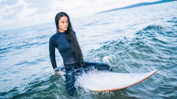 istock Asian female surfer in sea 1346121021